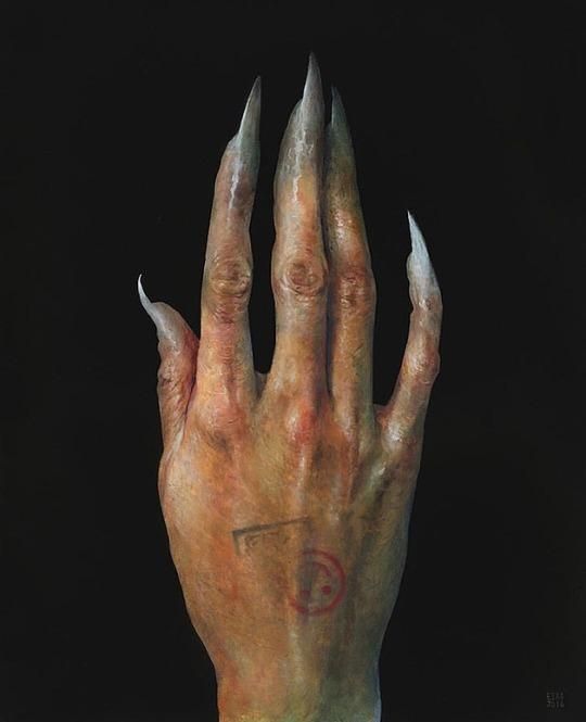 a grotesque hand with long, sharp fingernails and a tattoo on the palm is set against a dark background. the hand appears aged and possibly decaying, with an unsettling, monsterlike quality.