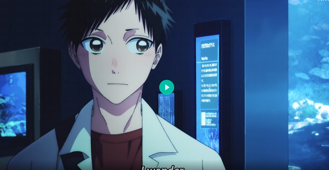 the image is a closeup shot of an animestyle young man. he appears to be a teenager with dark hair, brown eyes, and a slight blush on his cheeks.  he's wearing a lab coat over a dark red shirt.  the background depicts a dimly lit indoor setting, possibly an aquarium, with large screens displaying information in japanese, and a visible large fish tank. the overall atmosphere is moody and somewhat contemplative, emphasized by the dark lighting and the boy's thoughtful expression. a play button is visible in the center, suggesting the image is a still from an animated video.