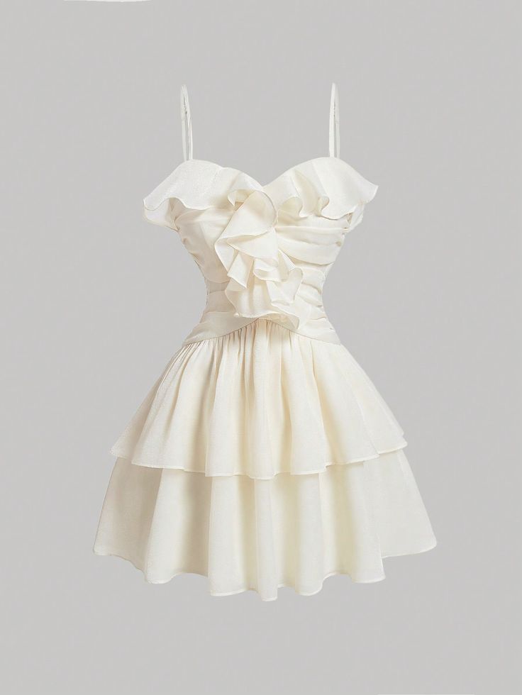 the image shows a white mini dress hanging against a light gray background. the dress has a sweetheart neckline with ruffled detailing and a tiered skirt. it has thin, adjustable spaghetti straps and a fitted bodice. the dress is made of a lightweight, flowy fabric.