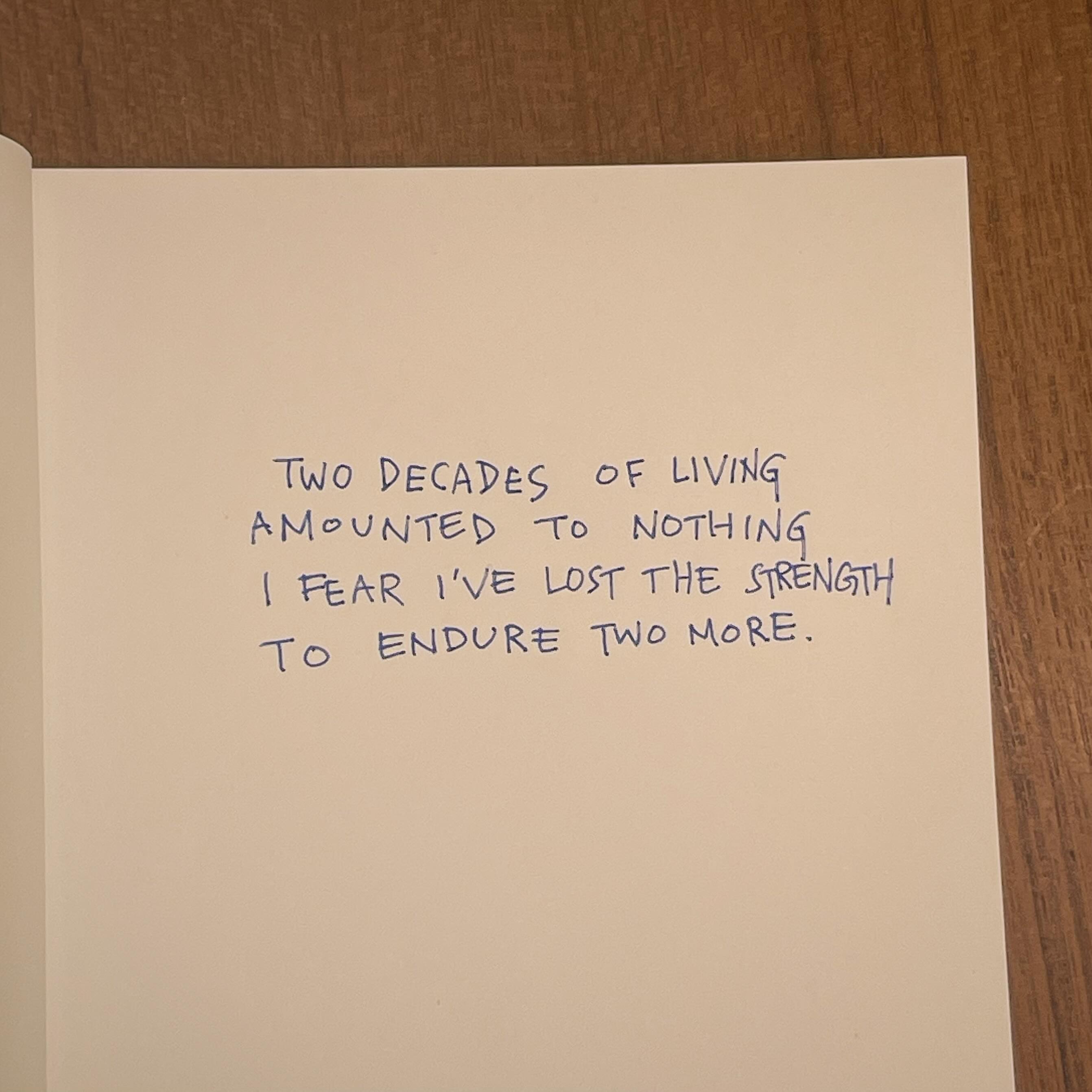 the image shows a page from a notebook with a handwritten note that reads: "two decades of livingamounted to nothingi fear i've lost the strengthto endure two more."the note expresses feelings of despair, hopelessness, and a lack of purpose in life.