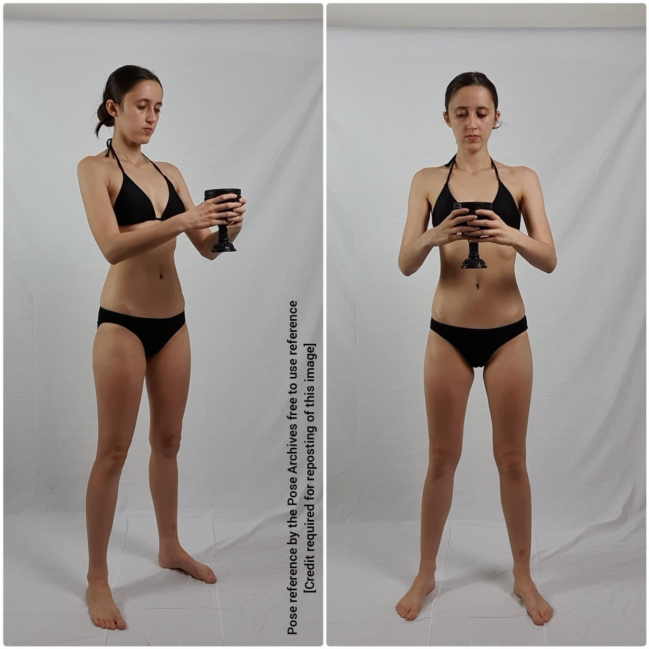a young woman in a twopiece black swimsuit is standing with her feet slightly apart, holding a darkcolored cup in both hands. she appears to be presenting or offering the cup, possibly as part of a ritual. the backdrop is a plain white wall, and the lighting is soft and diffused. the overall impression is one of simplicity and serenity.