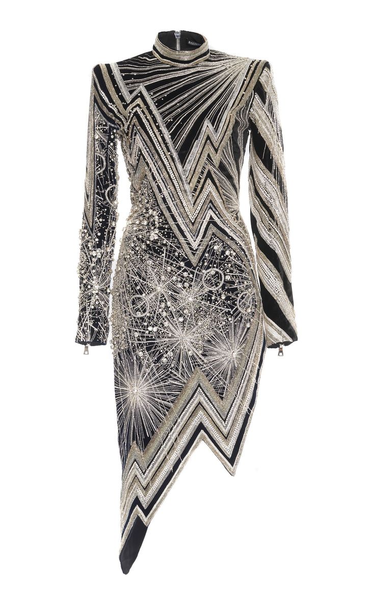 a black longsleeve dress heavily decorated with silver beading. the dress has a high neckline and an asymmetrical hem. the design features geometric patterns and bursts of beaded star shapes, suggesting designer evening wear.