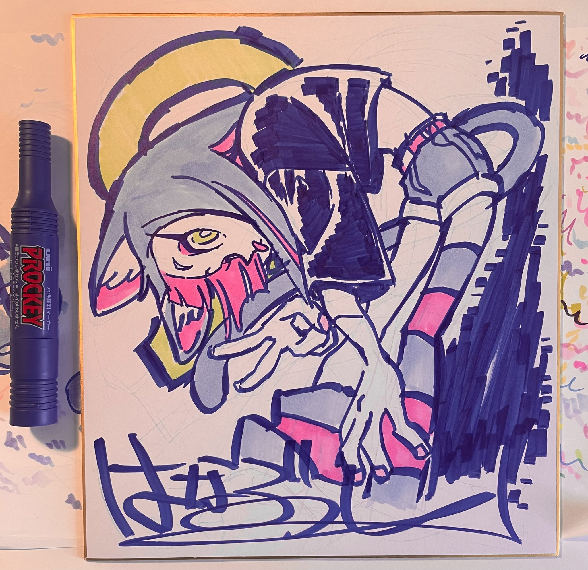 this is a drawing of a female monster with cat ears wearing streetwear in a dynamic pose. it's drawn on white paper with black, pink, blue, and yellow markers. a blue marker lays on the left side of the paper. the drawing is framed by the white paper which has a messy colorful scribble pattern on it. there is a signature on the bottom left of the drawing.