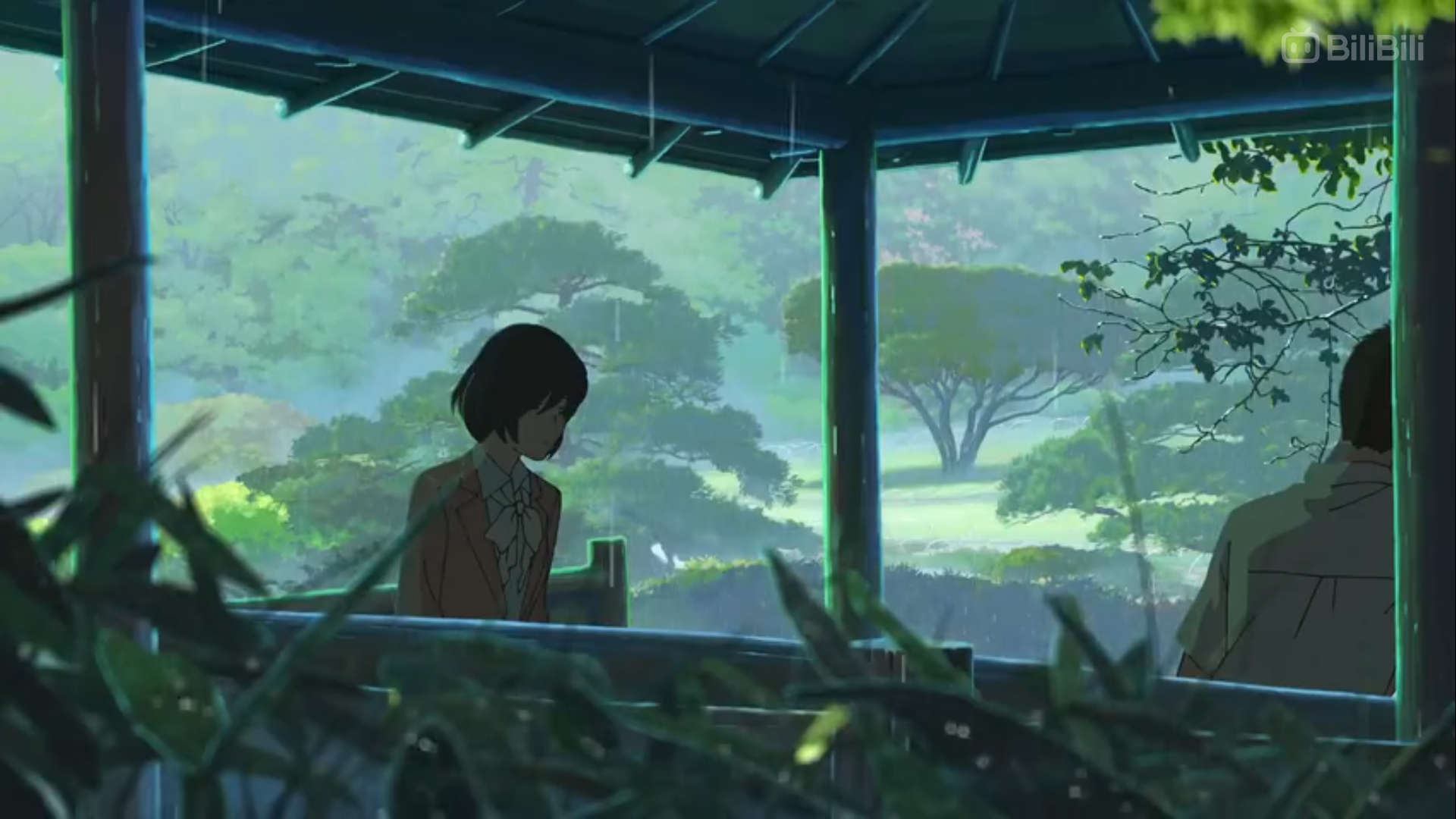 a young woman in a pink suit stands in a gazebo, gazing out at a lush, green garden. the rain falls softly, creating a misty atmosphere. a man, partially obscured by the gazebo's wooden frame, sits in the background. the overall mood is one of quiet contemplation and perhaps, a touch of melancholy.