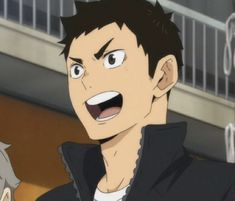 this is a fanart drawing of a male anime character with short brown hair and brown eyes. he has a happy expression on his face and his mouth is open as if he is talking. he is wearing a black jacket with a white shirt underneath. the background is blurred but appears to be indoors.  this is a closeup image.