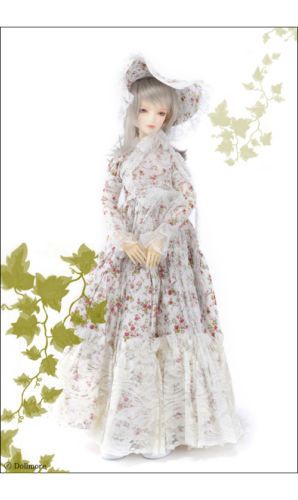 a balljointed doll with long silver hair and delicate features models a romantic, vintageinspired dress. the dress features a white lace overlay with a pink floral print and a flowing skirt with ruffles. the doll also wears a matching white lace hat. the backdrop is plain white, highlighting the delicate details of the dress and the doll's features. the soft lighting enhances the ethereal and romantic feel of the image.  to the left of the doll is a graphic design of ivy.