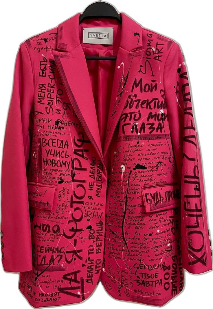 a pink blazer with black graffiti text all over it. it is a fashion item that is made of high quality materials and is likely to be expensive. the graffiti text is in russian and is likely to be related to art, fashion, and street wear. the blazer is a statement piece that is sure to turn heads.