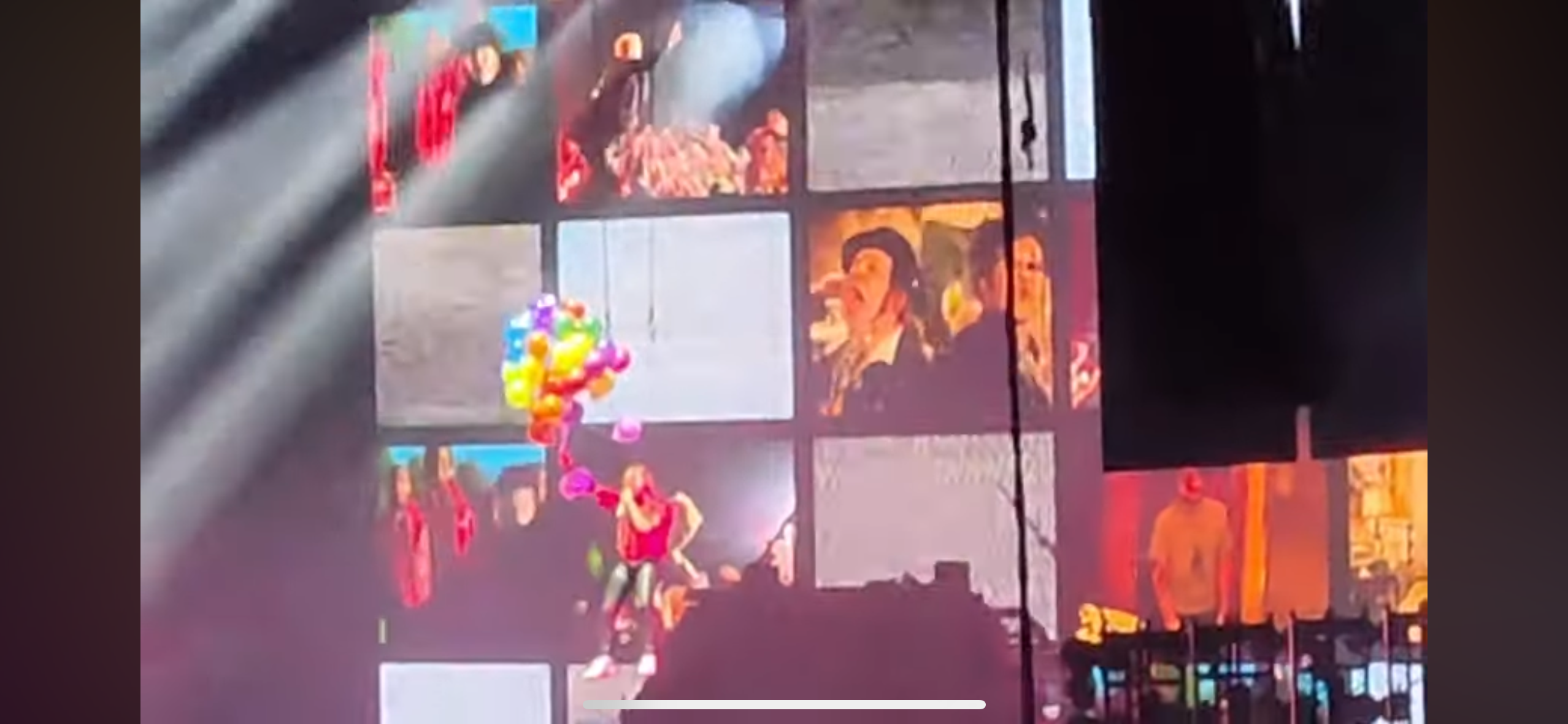 a screen with multiple videos of a music concert, showing a band performing on stage with colorful lights, balloons and a crowd watching.