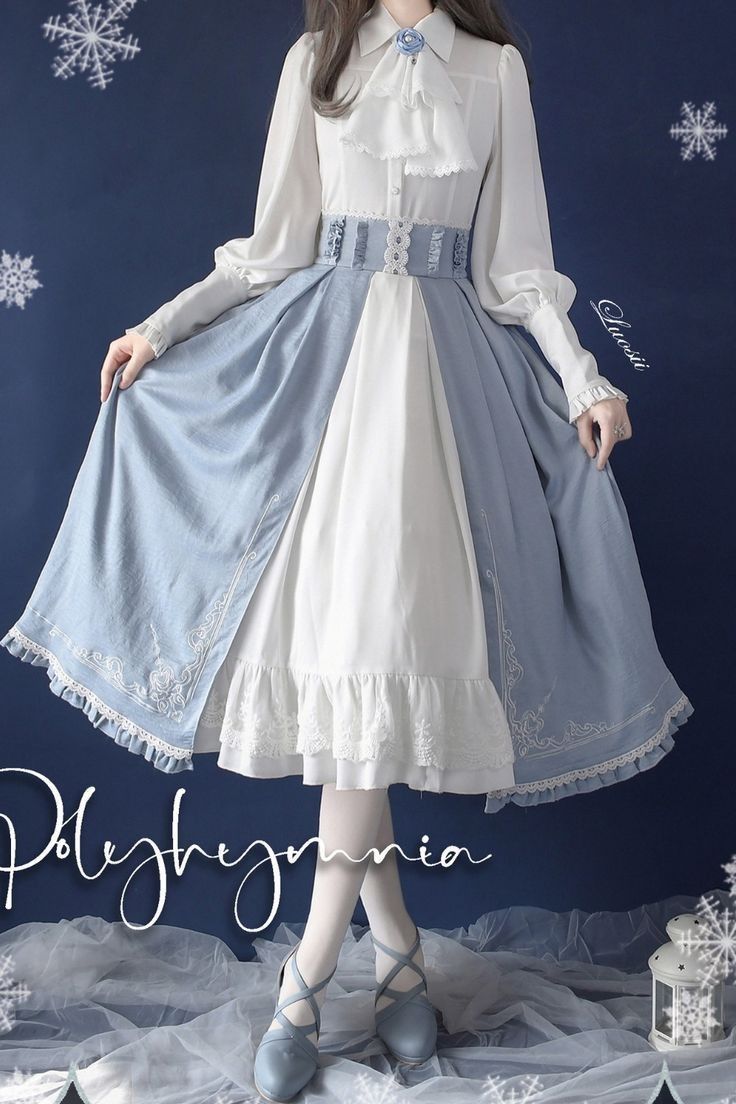 a woman is wearing a longsleeved lolita fashion dress in white and light blue. the dress features a high collar, a belted waist, and delicate embroidery. the skirt is full and layered, with lace trim. the woman is posing against a blue backdrop with snowflake decorations.  the lighting is soft and diffused, creating a dreamy and romantic atmosphere.