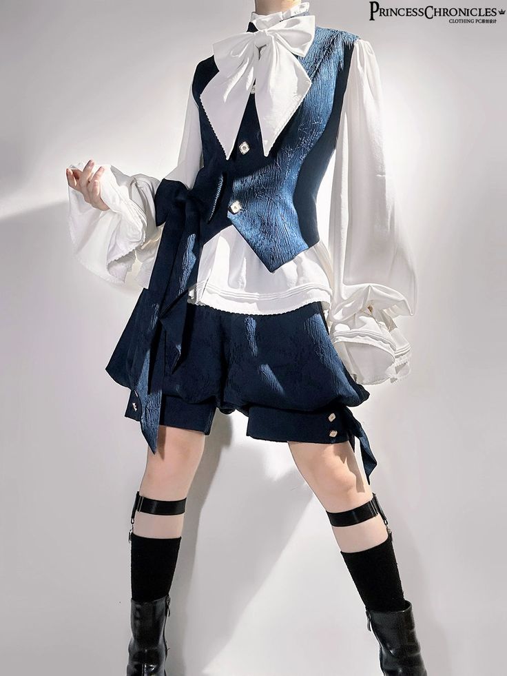 a full shot of a person wearing a blue vest over a white longsleeve blouse with a large bow and blue shorts. they are also wearing black knee socks with garters and black boots.