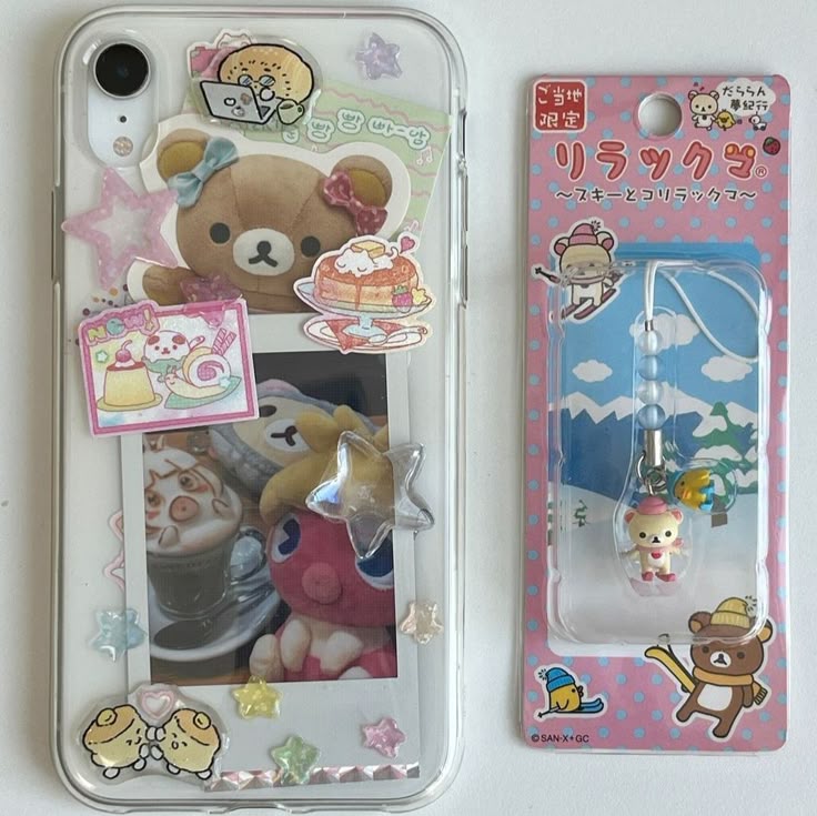 the image shows a clear phone case decorated with rilakkuma themed stickers and a rilakkuma keychain still in its packaging. the phone case features stickers of various rilakkuma characters and dessertthemed images. the keychain is a rilakkuma figure on skis and is in a pink package with a winter scene background.