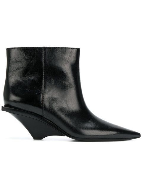 a black leather ankle boot with a pointed toe and a unique wedge heel.