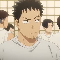 this is a closeup illustration of a male anime character with short black hair and stubble. he appears to be a young adult and is looking directly at the viewer with a serious or intense expression. he's in a locker room setting, evident from the lockers in the background, with other characters out of focus behind him. the overall palette is warm and the lighting soft.  the focus is on the central character's face and upper torso, emphasizing his expression.  the illustration style leans towards realism within its anime aesthetic.