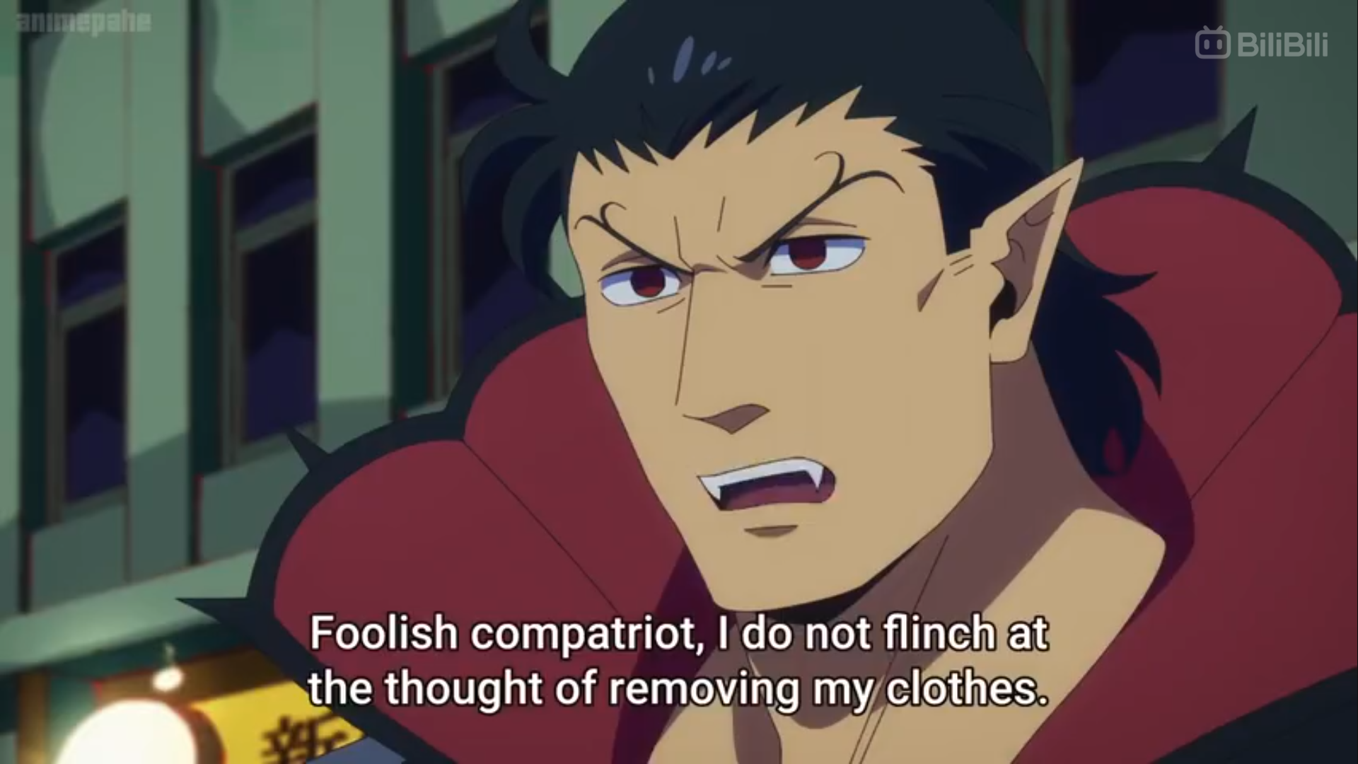 a screenshot of an anime character with short black hair, red eyes, and a redlined black collared shirt that covers part of his mouth, revealing fangs. the image is from the chest up and slightly angled, with the character looking slightly to the left of the viewer with an intense expression. there's a speech bubble that reads, "foolish compatriot, i do not flinch at the thought of removing my clothes." the background shows blurred buildings, street lights, and a green and yellow sign with asian lettering.```