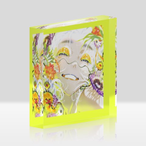 this is an acrylic block featuring a colorful illustration of a woman surrounded by flowers. the woman has white hair and yellow makeup around her eyes.  the flowers are primarily yellow, orange, and purple. the background is white. the acrylic block is a bright yellow color.