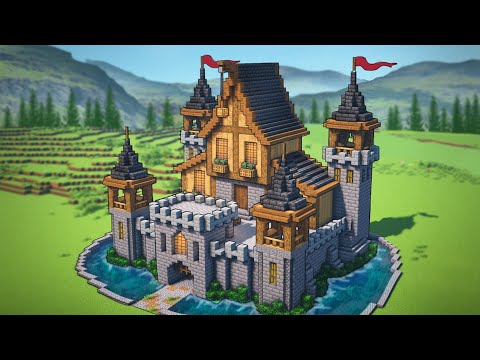 a large, gray and brown minecraft castle sits in a grassy field by a river. the castle has three towers and a gatehouse. the walls are made of gray cobblestone and the roofs are made of brown wood. there are flags flying from the tops of the towers. the castle is surrounded by a moat of blue water. the background is a mountain range.