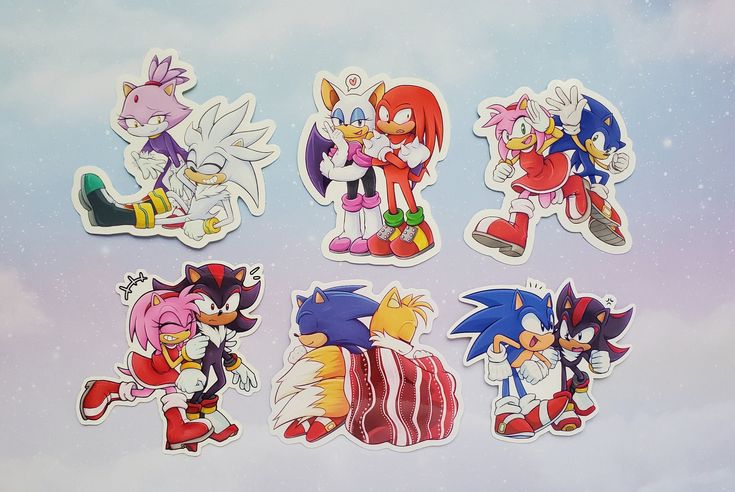 the image shows a collection of fan art stickers featuring various sonic the hedgehog characters in friendly or romantic pairings. the stickers include blaze and silver, rouge and knuckles, amy rose and sonic, amy rose and shadow, sonic and tails bundled in a blanket, and sonic and shadow. the stickers are displayed against a light background with a slight gradient.