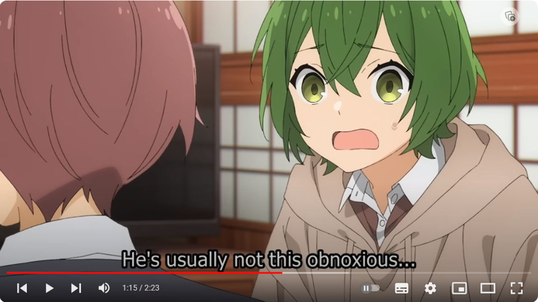 a screenshot from an anime featuring a closeup of a surprisedlooking female character with bright green hair. she has large, expressive eyes with a shocked expression. she is wearing a light brown hoodie. in the background is a male character with brown hair and a neutral expression, but only part of his face is visible. the scene appears to be a conversation taking place in an interior setting, indicated by the wall in the background. the overall lighting is soft and warm.
