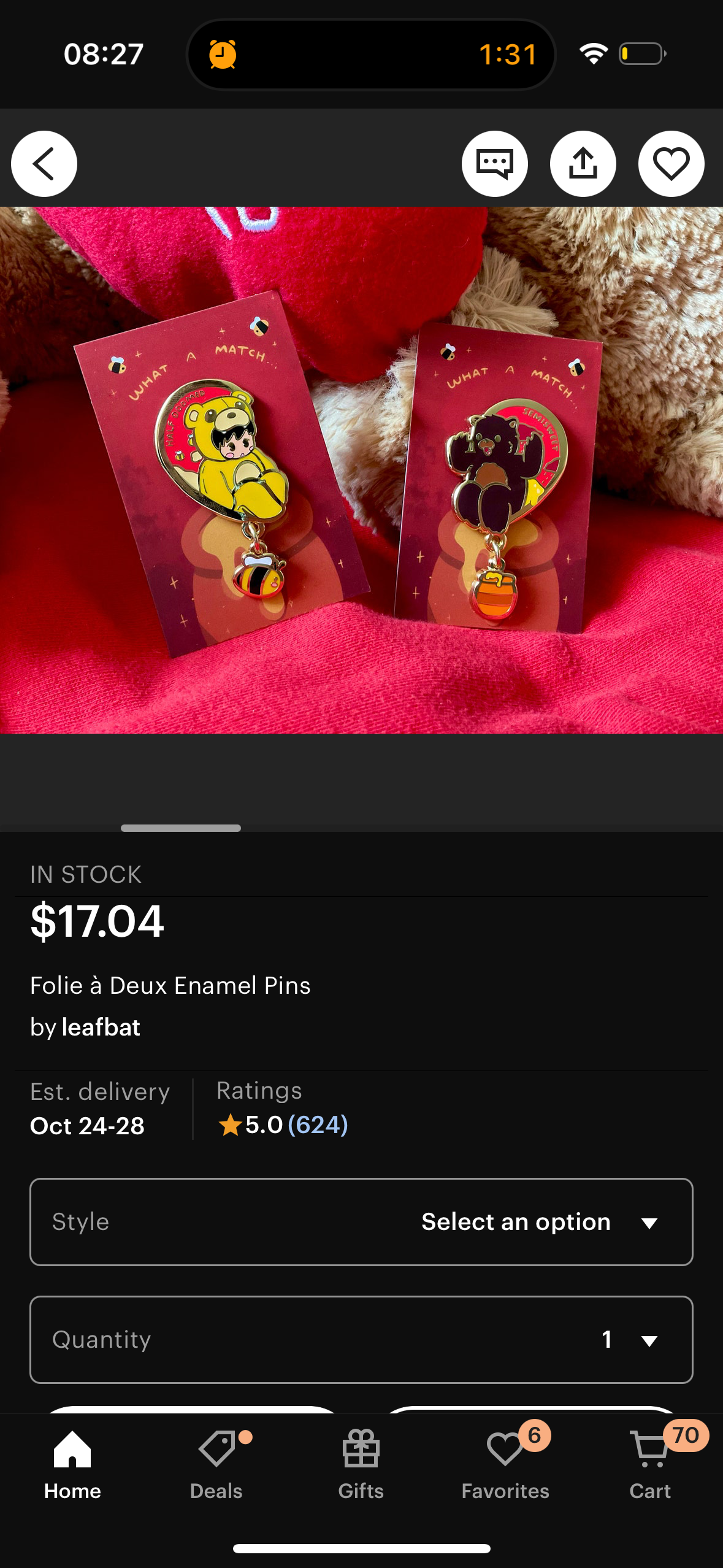 this image shows a listing for a set of two enamel pins, featuring a bee and a bear. the pins are described as "folie à deux enamel pins" and are sold by the shop "leafbat." they appear to be a cute and fun way to express friendship or love.  the image also shows a close up of the pins in a colorful and cute style.  the image also shows a small shopping cart icon in the bottom right corner, suggesting that these pins are available for purchase.