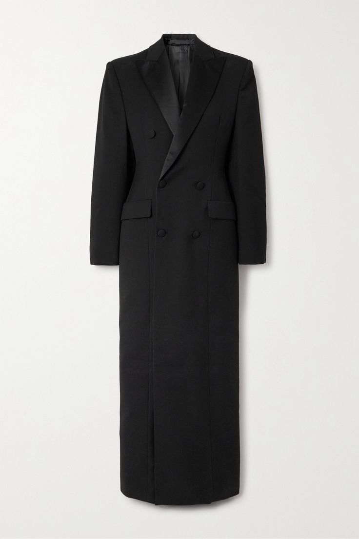 a black doublebreasted coat, long and slim fitting, giving a tailored and elegant look. the coat is likely made of highquality wool or cashmere, giving it a luxurious feel. the doublebreasted closure and tuxedo style collar add a formal and sophisticated touch. the clean lines and minimalist design make this coat a timeless piece that can be dressed up or down.