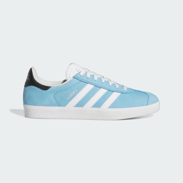 a pair of light blue adidas gazelle shoes with white stripes and a black heel tab are shown on a white background. the shoe is a classic style that is perfect for everyday wear.  they are designed for comfort and versatility.  the shoes have a sporty look and feel, and they are perfect for both casual and athletic activities.