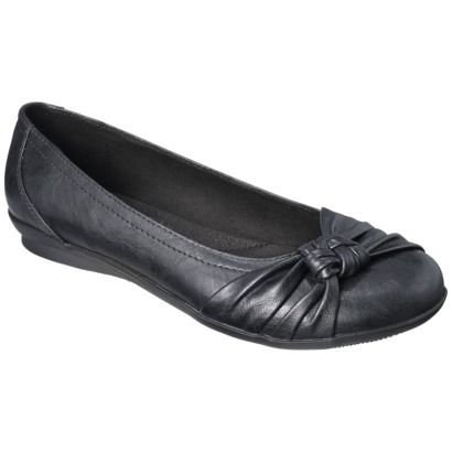 a single black leather ballet flat is shown at an angle against a white background. the shoe is a dark color, with a knotted design on the toe. the inside of the shoe is visible and also dark. the sole is very thin and low to the ground.