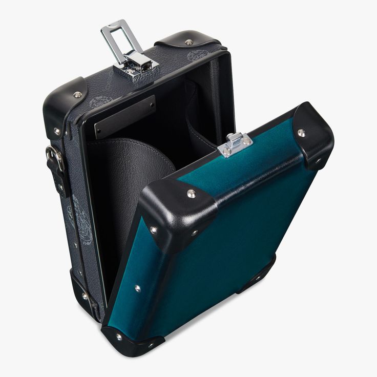 an open briefcase on a white background. the briefcase is made of leather, with a turquoise interior and black corner protectors. it has a latch on the top and a handle on the side.