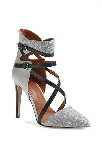 a pair of women's formal heels with a silver glitter and grey leather pointed toe. they have multiple black straps and buckles around the ankle and foot. the heels are stiletto heels.