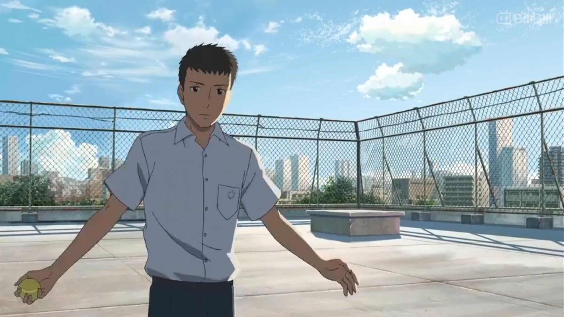 an anime boy in a school uniform stands with his arms outstretched on a rooftop with a chain link fence in the background. the boy is holding a yellow object in his right hand. the city skyline is visible in the background. the sky is blue and cloudy.