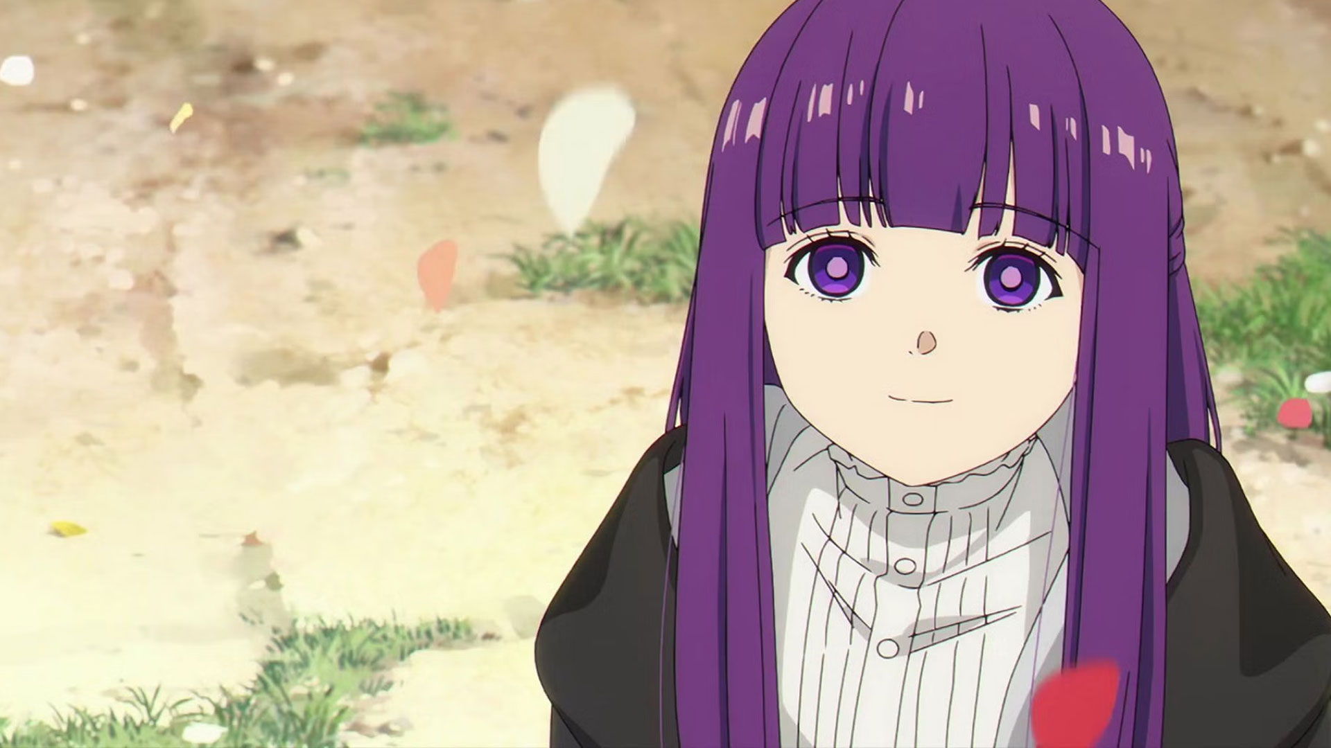 a young anime girl with purple hair and purple eyes is smiling at the viewer.  she has a black jacket over a white blouse. the ground around her is tan, with scattered green grass.  red and white flower petals are blowing in the wind.  the lighting is bright and sunny.