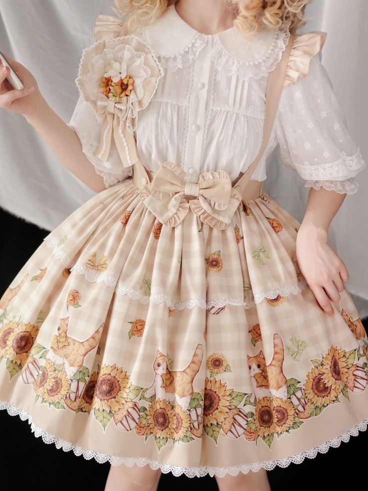 a woman is wearing a white blouse with a sunflower corsage and a beige and white checkered lolitastyle skirt with a sunflower and cat print.