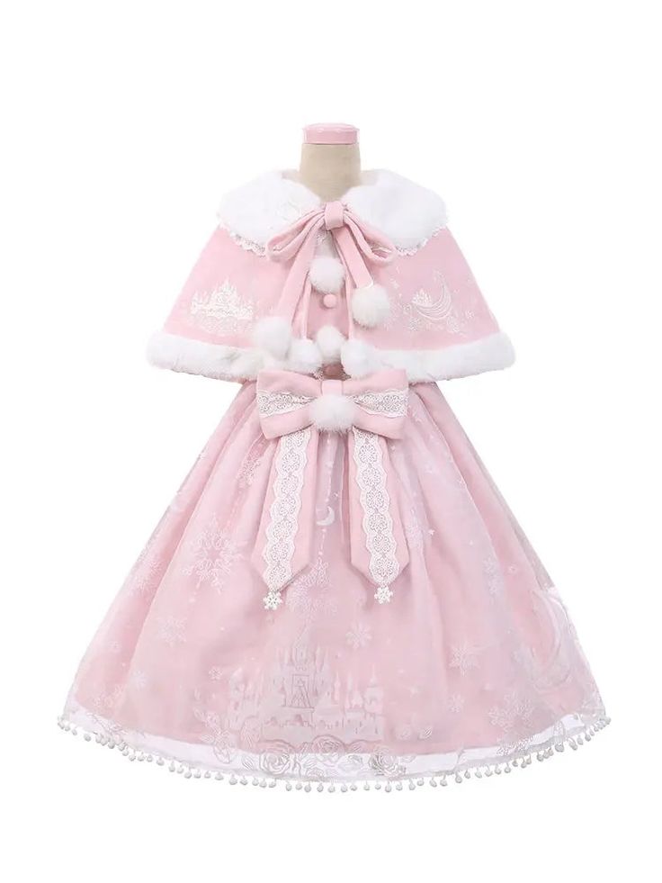 the image shows a pink lolita dress with a matching capelet. the dress is adorned with snowflake and castle prints, while the capelet features white faux fur trim and pompoms.