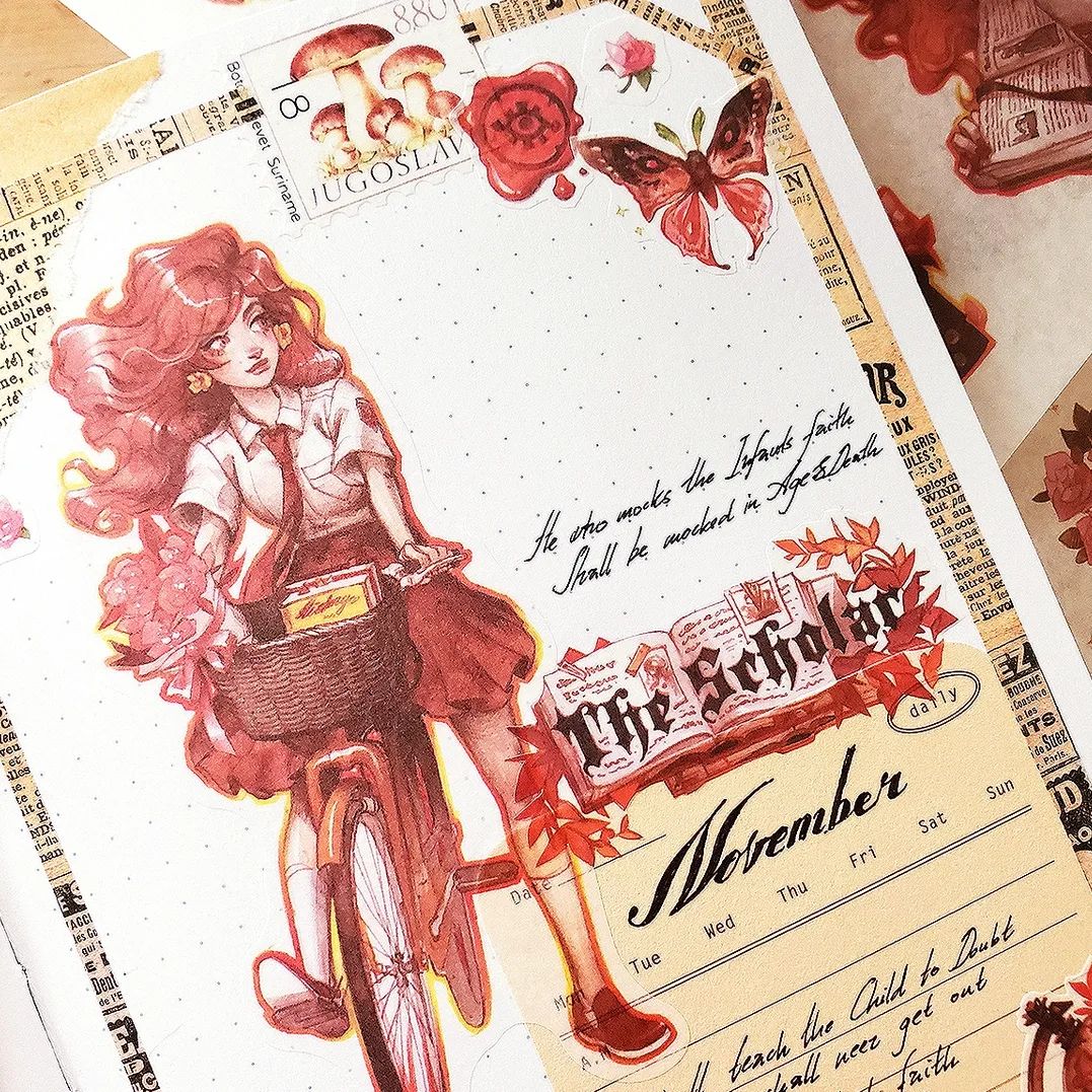 a closeup shot of a journal spread decorated with various stickers and washi tape. the theme appears to be autumnal or fall, with a vintage aesthetic.  a central element is a watercolorstyle illustration of a girl riding a bicycle, carrying books in a basket. surrounding this are stickers depicting mushrooms, butterflies, a wax seal, books, and autumn leaves.  text elements include a calendar for november and a quote. the overall style is reminiscent of scrapbooking or art journaling.  the color palette is predominantly reds, browns, and yellows.