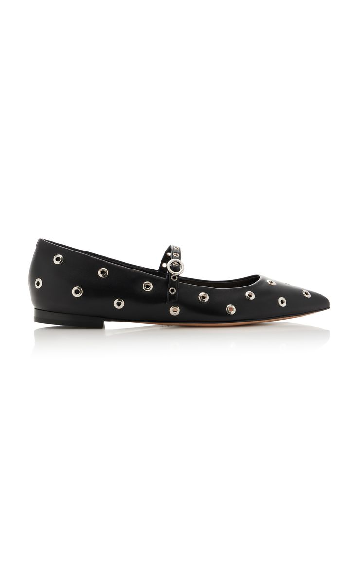 a pair of black leather mary jane flats with silver eyelets. the shoes are pointedtoe and have a simple strap across the instep. they are shown on a white background.