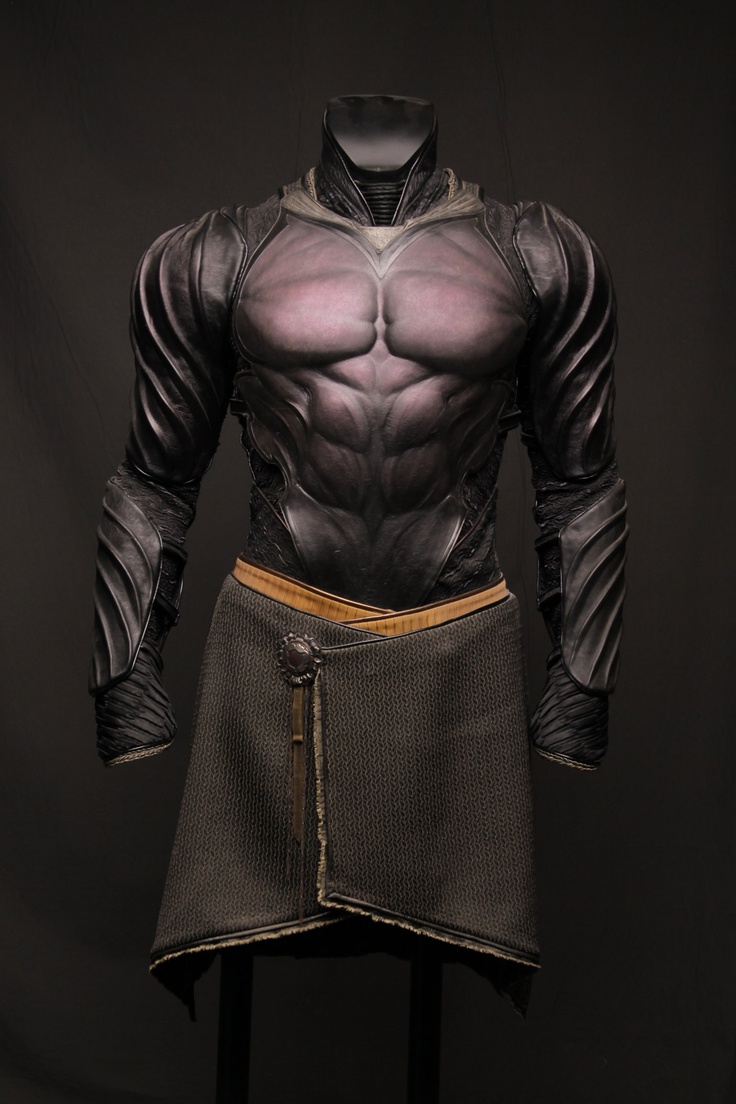 a dark, leatherclad warrior costume with sleek, sculpted armor. the figure is muscular and powerful, with a grey and brown color scheme. the costume is detailed with decorative elements, and it gives the impression of a futuristic or fantasy warrior.