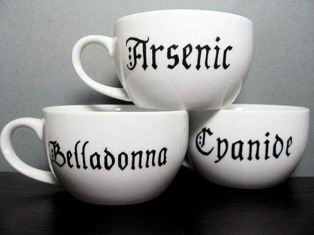 the image shows three white mugs stacked on top of each other. each mug has a word written on it in black text: "arsenic" on the top mug, "belladonna" on the left mug, and "cyanide" on the right mug. the words suggest that the mugs are meant to hold poison.