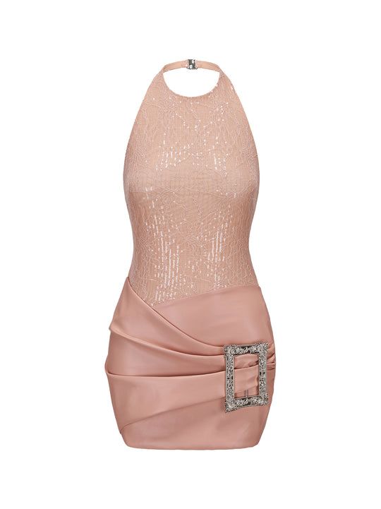 a pink halter top mini dress with sequin detailing on the bodice and a large decorative buckle on the draped skirt. the dress appears to be designed for a cocktail party or formal event.