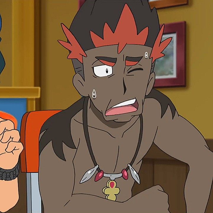 a male anime character is shown from the chest up with a surprised expression. he has red hair and a red necklace with feathers and a golden cross. his skin is brown. he has a hand up in front of him and looks shocked and worried. the background is blurry with wood tones.
