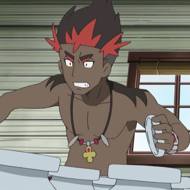 an anime character, a male human with black skin, red and black hair, and a muscular chest, is shown with his shirt off. he is wearing a necklace with a pendant and is holding a white object in his hand. he looks angry and has an open mouth showing his teeth. the background shows a wooden wall with a window. the room looks like it's from a house interior. the character looks like it could be from the pokemon series.