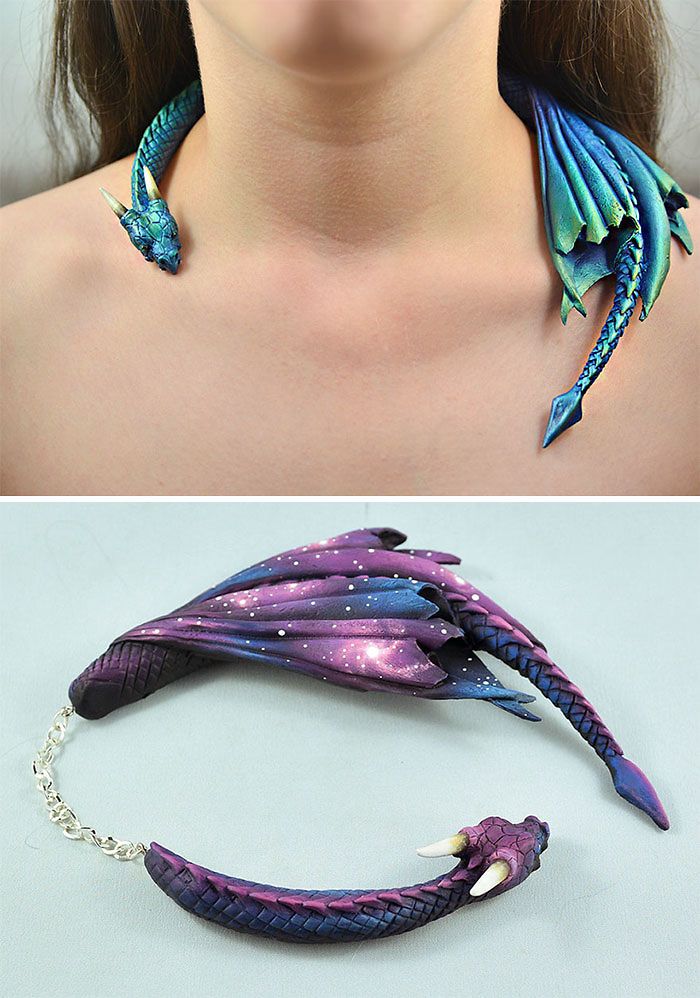 the image shows two perspectives of a handcrafted dragon necklace. the top image features the necklace being worn, showcasing a blue and green iridescent dragon with its head on one side of the neck and its wings and tail draping down the other side. the bottom image displays the same necklace laid flat, revealing a different color scheme with purple and blue scales, and wings designed with a cosmic pattern of stars. a chain connects the head and wing sections of the necklace.