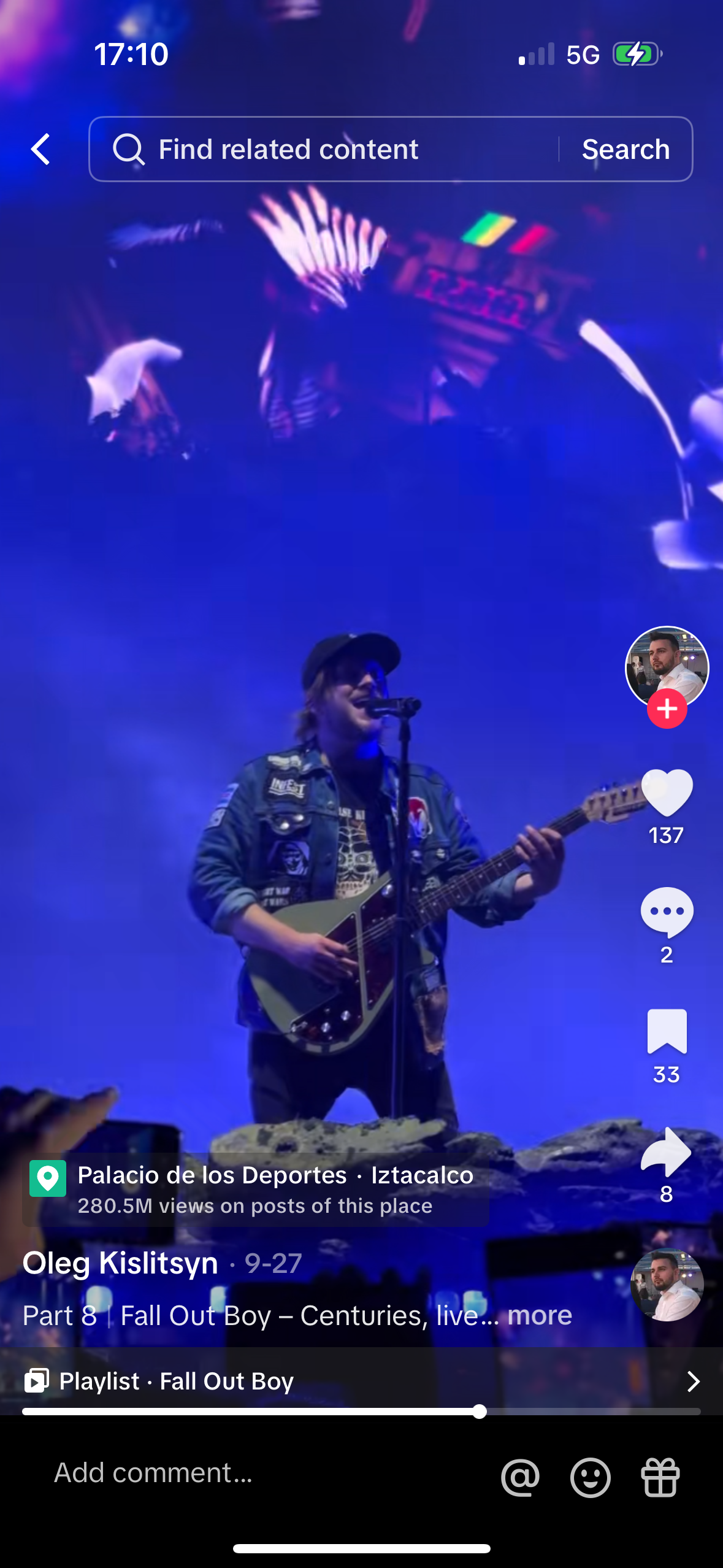 a live performance of the band fall out boy. the lead singer is playing guitar and singing. the band is playing in front of a large crowd of fans. the stage is lit with colorful lights. the audience is cheering and enjoying the show.