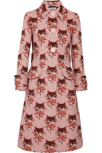 a pink overcoat with a pattern of foxes and floral designs.