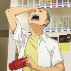 a young man with short hair and a distressed expression stands in front of a vending machine. he is wearing a white, shortsleeved, collared shirt with the top button undone over a yellow tshirt. his right hand is holding his head and his mouth is open, as if he is yelling in frustration. in his left hand, he holds a red object that appears to be a wallet. he is standing in a welllit room with a vending machine filled with drinks behind him. the vending machine is white and stocked with a variety of beverages in colorful cans and bottles. the wall behind the vending machine is a light yellow. the overall atmosphere suggests a moment of stress or disappointment.
