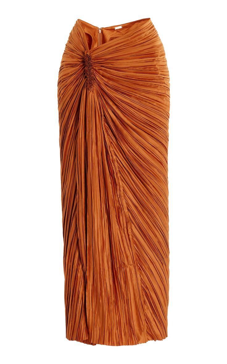 this is a rustcolored pleated midi skirt. the skirt is made from a soft, flowing fabric and has a high waisted design.  the skirt has a unique and stylish twist, with its pleated fabric and diagonal folds. the skirt is perfect for a variety of occasions, from casual to formal.