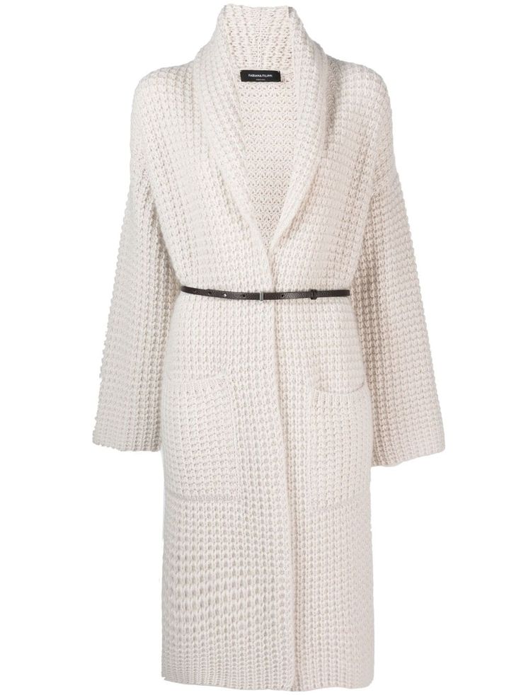 a white knitted cardigan with a long sleeve, belted waist.  the cardigan is shown on a model and has a loose fit.  it appears to be very warm and comfortable.