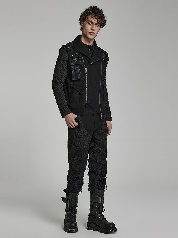 a fullbody studio shot of a male model showcasing a gothicinspired outfit. he is wearing a black studded vest over a black longsleeved shirt, distressed black jeans, and black combat boots. the model is posing against a neutral gray background.  the overall style is dark, edgy, and fashionable.