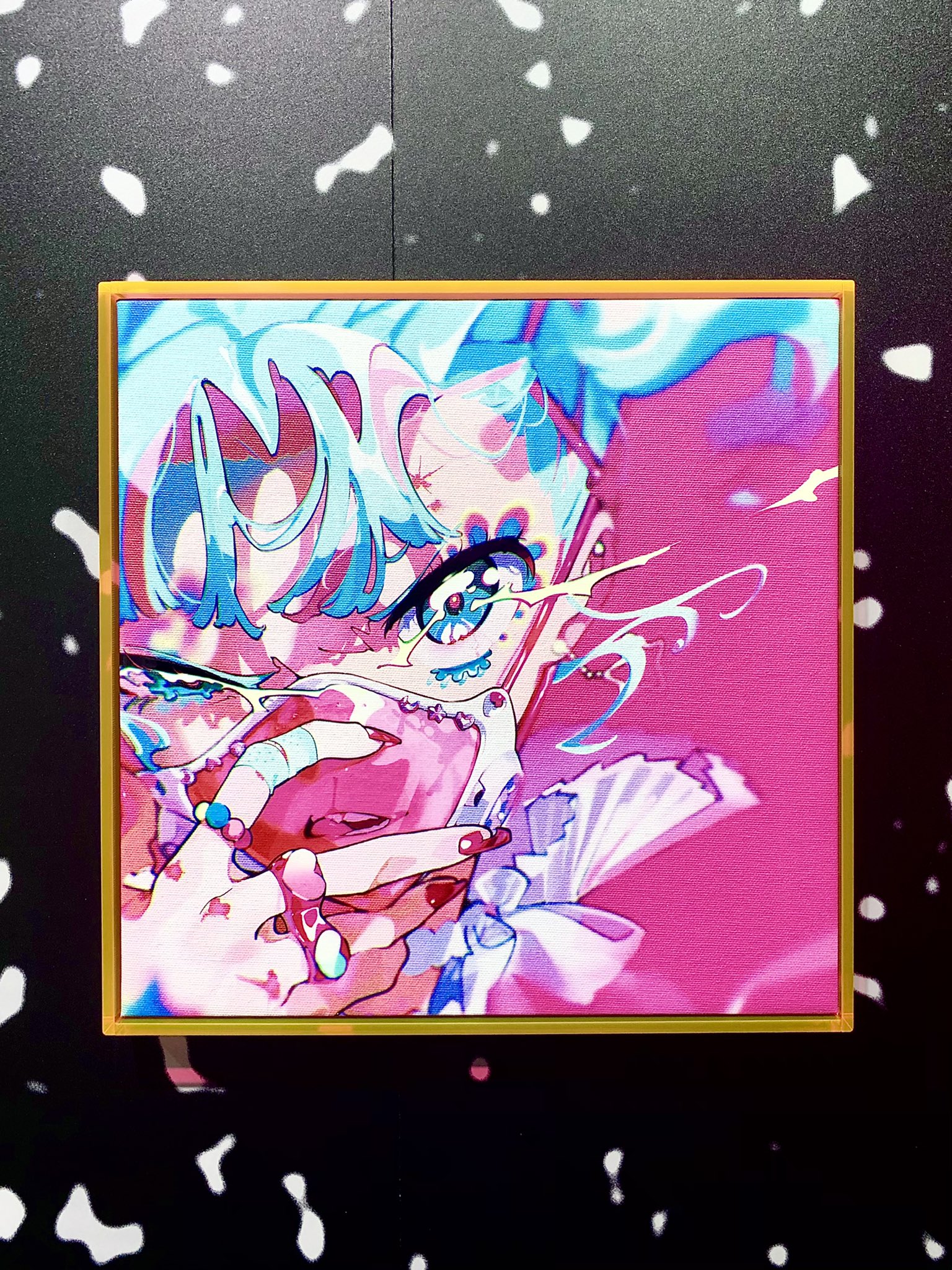 a vibrant, digital artwork displayed in a gallery setting. the artwork features a closeup portrait of a woman with turquoise hair and pink accents. her style leans into a cyberpunk, anime aesthetic, and her image has a glitching effect. the artwork is framed in gold and set against a black wall with white speckles.