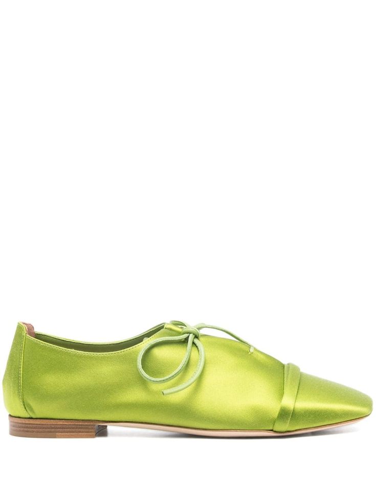 a pair of women's lime green satin flats with a square toe and laceup detail. the shoes have a low heel and a simple, minimal design, making them perfect for spring and summer. they are elegant and stylish, and would be a great addition to any fashionconscious woman's wardrobe.