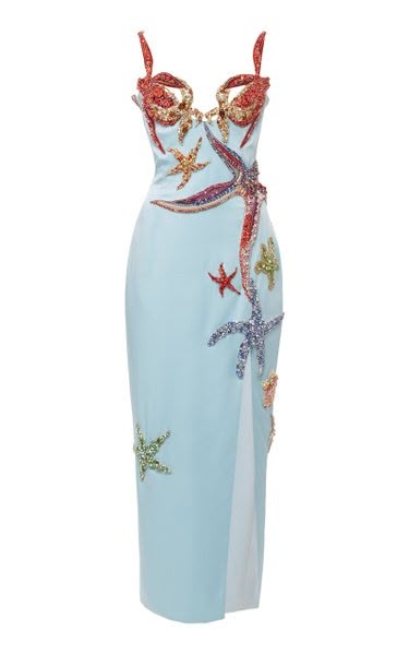 a light blue formal dress adorned with starfish embellishments is displayed against a white background. the dress features a fitted silhouette, a bustier top with decorative spaghetti straps, and a slit. the starfish are multicolored and embellished with sequins, creating an oceanthemed aesthetic.