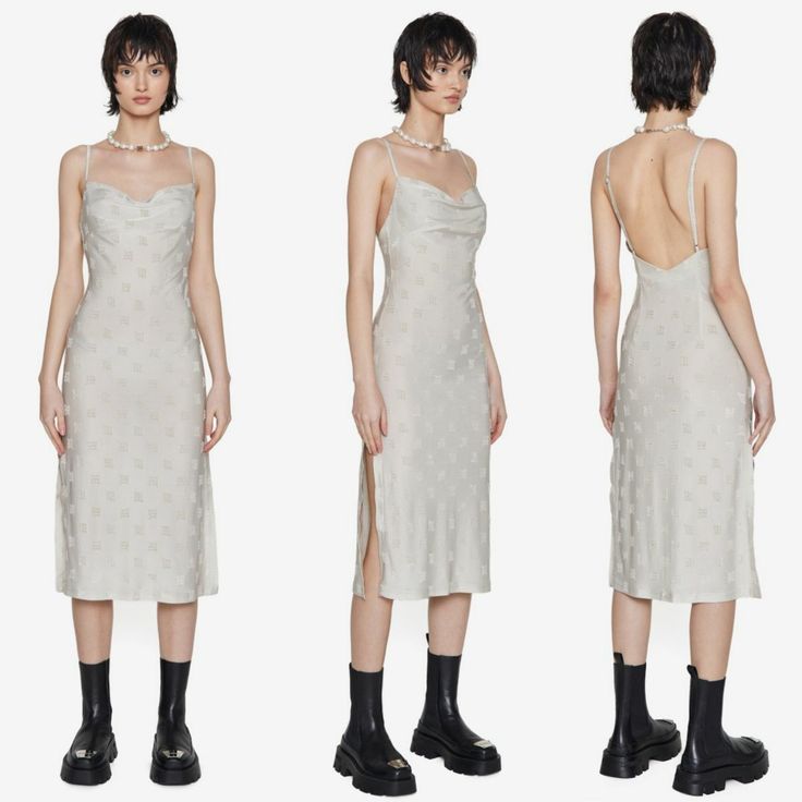 hree views of a female model showcasing a light beige midi slip dress with a cowl neck and side slit. the dress features an embossed pattern. the model is wearing a pearl necklace and black ankle boots. the backdrop is a clean white studio background.  the images are styled to highlight the dress from front, side, and back perspectives.